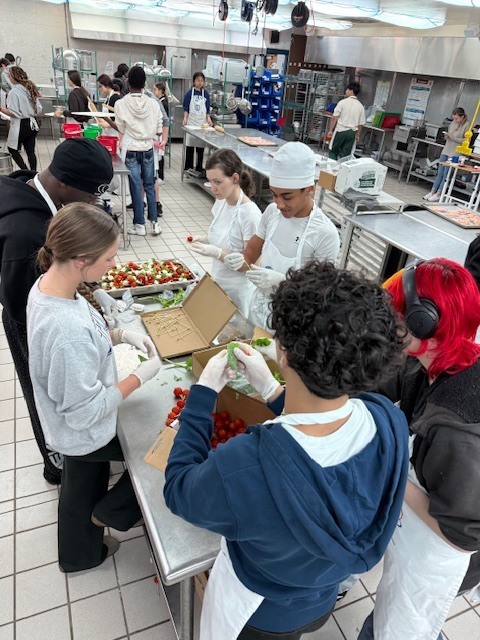 Recently, our Culinary students worked hard to prepare an incredible meal for the Clay Can Dance event. Students pounded out 250 pieces of chicken, and Mrs. Stevens’ 3rd period was a tremendous help during the preparation process while many students were away at Grad Bash.  The menu featured rolled chicken stuffed with spinach and Boursin cheese, Caprese skewers, salad, green beans, meatballs, bruschetta, molded butter, and mashed potatoes. A special thank you goes to Angelica, Mariah, and Sidney, who came in on Saturday to help finish the meal and prepare the mashed potatoes for pick up.  We are proud of the teamwork, dedication, and talent our students demonstrated, and we are so glad the guests enjoyed the meal.