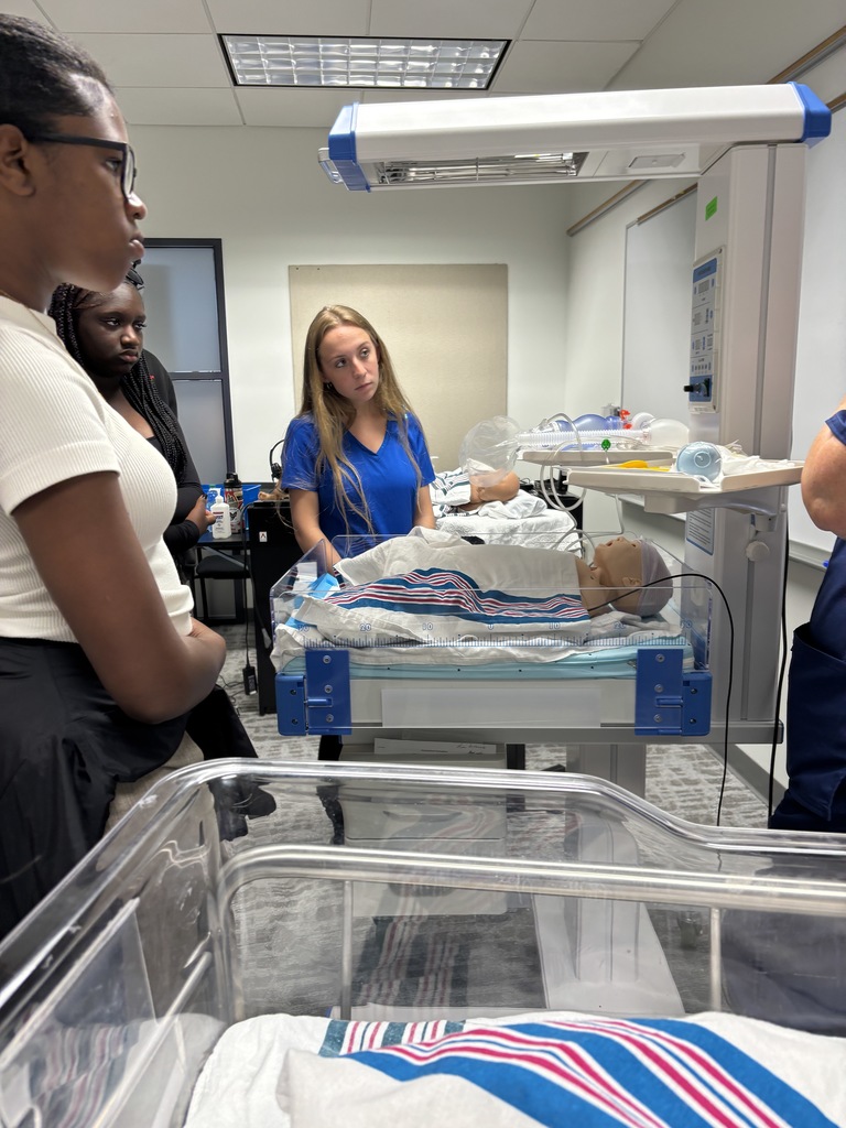 Our Health Science and HOSA students had a fantastic visit to the University of North Florida today. Faculty from the Brooks College of Health introduced students to the many degree programs available and shared valuable insight into careers in the healthcare field. Students also participated in a question and answer session with professors and senior nursing students, giving them a firsthand look at college life, coursework, and future opportunities. After the presentation, students enjoyed a guided walking tour of campus followed by lunch at the Osprey Café. The group then traveled to the MedNexus Simulation Lab at Deerwood, where they explored high fidelity mannequins used in medical training and practiced skills such as performing CPR, placing an NG tube, checking a pulse, and other hands on activities. It was an incredible experience that allowed students to see the pathways and possibilities waiting for them after high school.