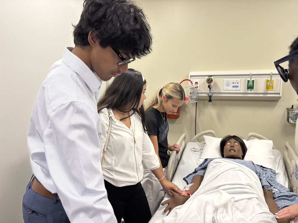 Our Health Science and HOSA students had a fantastic visit to the University of North Florida today. Faculty from the Brooks College of Health introduced students to the many degree programs available and shared valuable insight into careers in the healthcare field. Students also participated in a question and answer session with professors and senior nursing students, giving them a firsthand look at college life, coursework, and future opportunities. After the presentation, students enjoyed a guided walking tour of campus followed by lunch at the Osprey Café. The group then traveled to the MedNexus Simulation Lab at Deerwood, where they explored high fidelity mannequins used in medical training and practiced skills such as performing CPR, placing an NG tube, checking a pulse, and other hands on activities. It was an incredible experience that allowed students to see the pathways and possibilities waiting for them after high school.