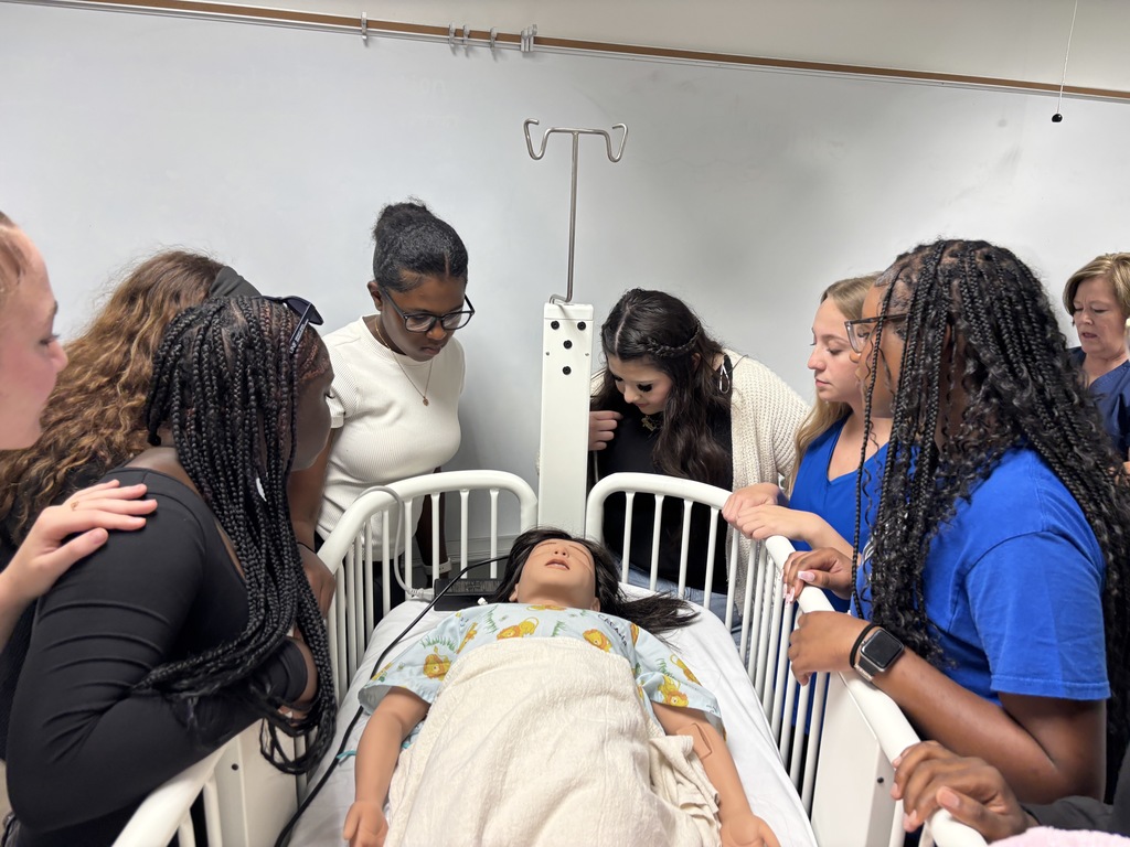 Our Health Science and HOSA students had a fantastic visit to the University of North Florida today. Faculty from the Brooks College of Health introduced students to the many degree programs available and shared valuable insight into careers in the healthcare field. Students also participated in a question and answer session with professors and senior nursing students, giving them a firsthand look at college life, coursework, and future opportunities. After the presentation, students enjoyed a guided walking tour of campus followed by lunch at the Osprey Café. The group then traveled to the MedNexus Simulation Lab at Deerwood, where they explored high fidelity mannequins used in medical training and practiced skills such as performing CPR, placing an NG tube, checking a pulse, and other hands on activities. It was an incredible experience that allowed students to see the pathways and possibilities waiting for them after high school.
