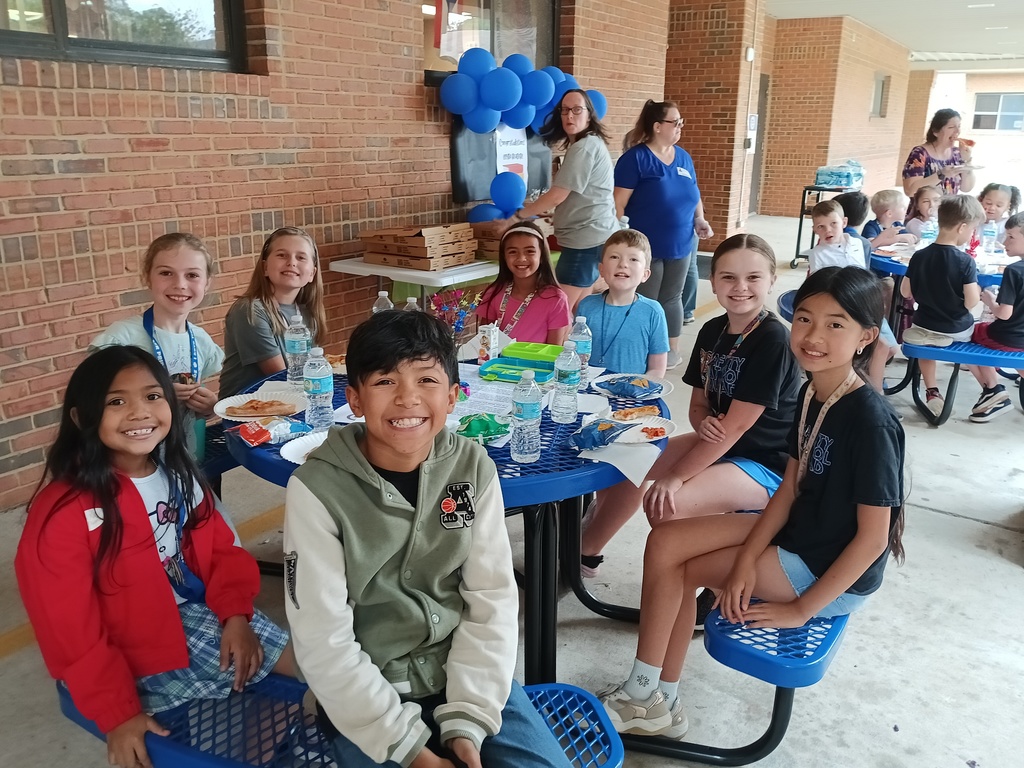 students sitting at a picnic table