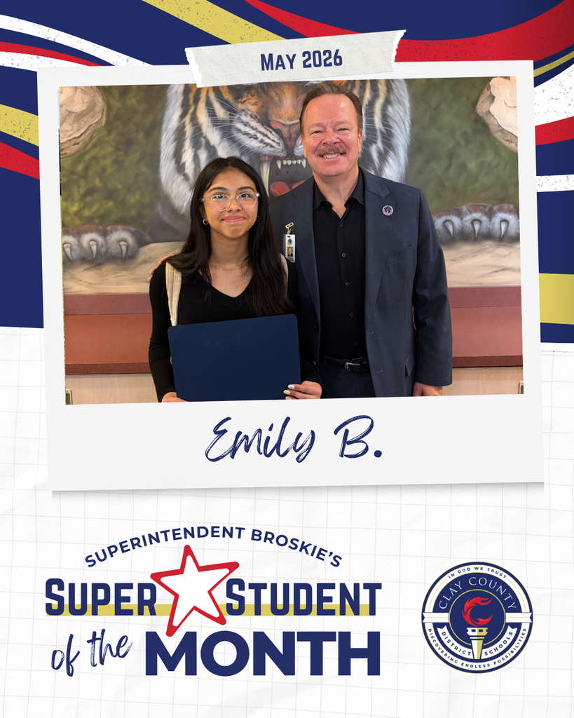 A man and woman pose with a blue folder before a tiger mural. Text reads: Superintendent Broskie's Super Student of the Month, Emily B.