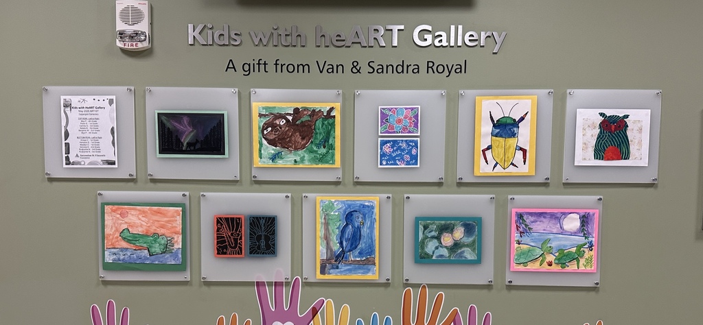 A wall with a sign "Kids with heART Gallery" displays several children's artwork. Drawings include animals and landscapes.