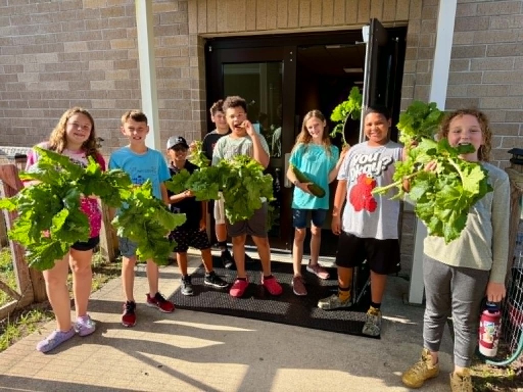 🥒🥗UE Veggie Garden🥗🥒 What a harvest from our UE vegetable garden! They picked some great huge zucchini and lots of lettuce. They gifted the biggest one to Mrs. Dryden as a surprise!