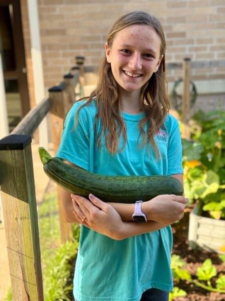 🥒🥗UE Veggie Garden🥗🥒 What a harvest from our UE vegetable garden! They picked some great huge zucchini and lots of lettuce. They gifted the biggest one to Mrs. Dryden as a surprise!