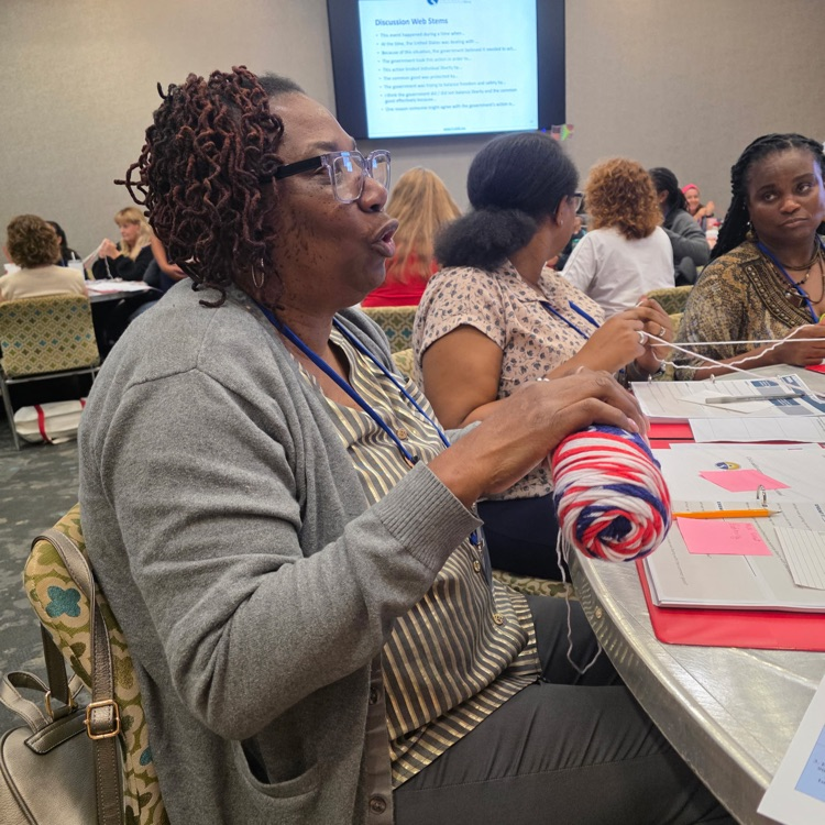A photo of Mrs. Johnson engaged with the lesson at the workshop