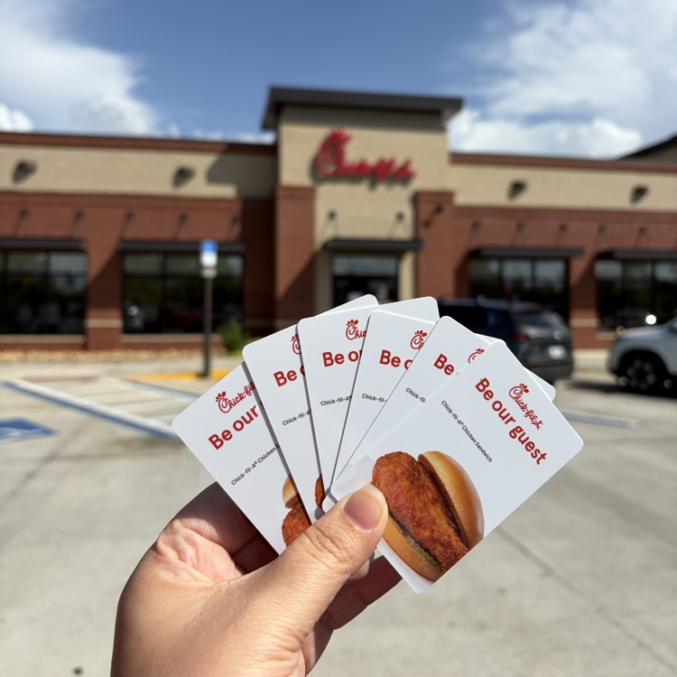 holding Chick-fil-A sandwich cards