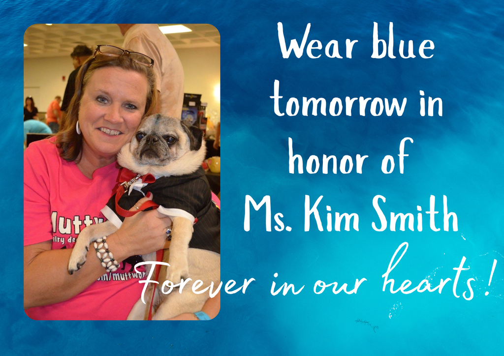 A smiling woman in a pink shirt holds a pug wearing a black shirt with text. Blue background and overlay text reads "Wear blue tomorrow in honor of Ms. Kim Smith".
