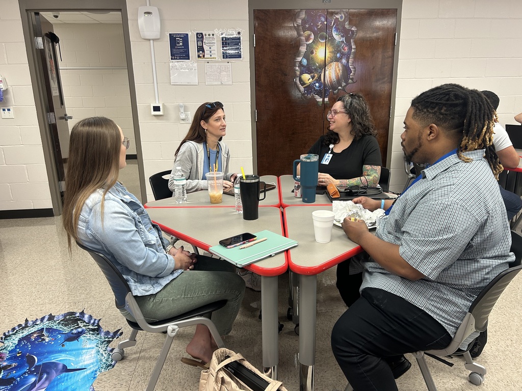 a classroom with teachers discussing their thinking with one another