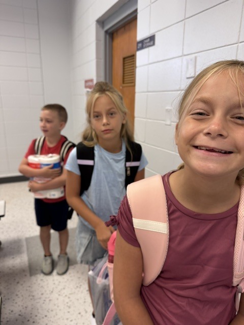 Three kids with backpacks.