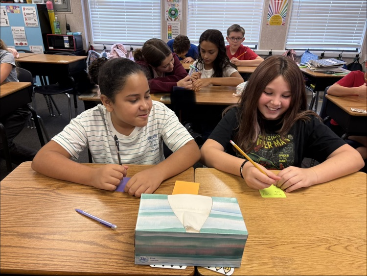 miss Myers’s class working on a writing project