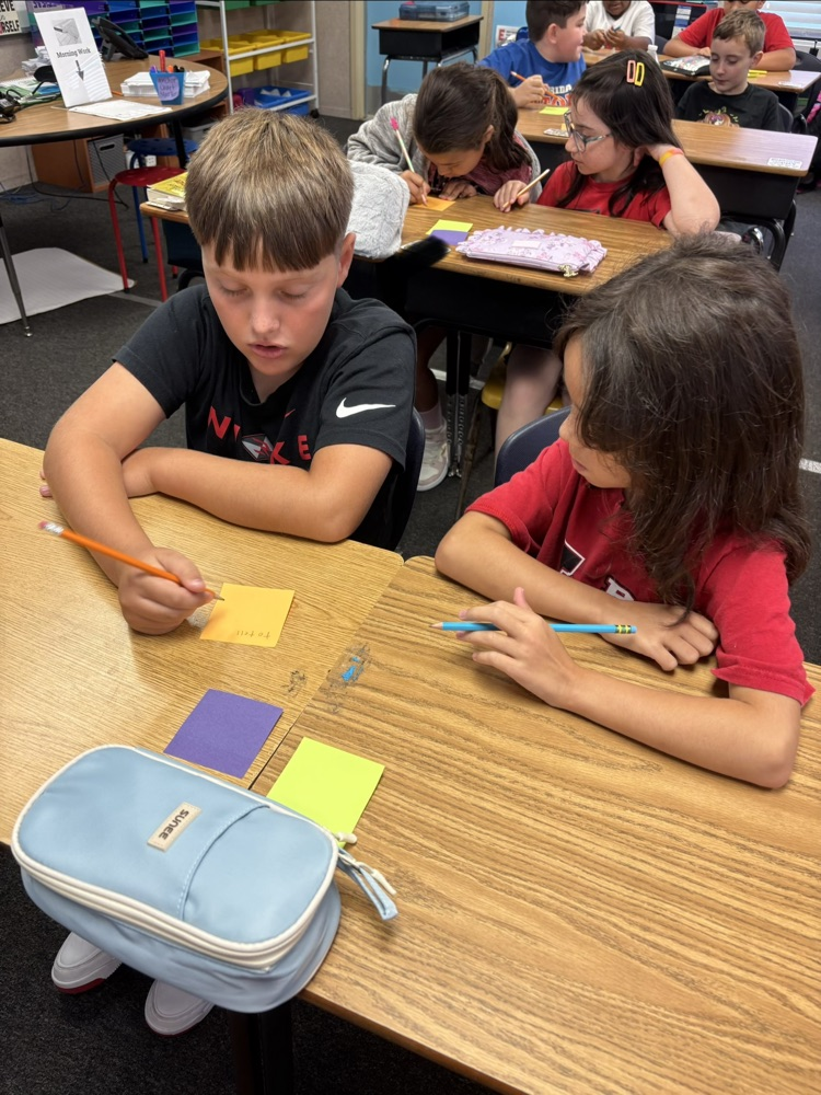 mrs. Myers class working on a writing project