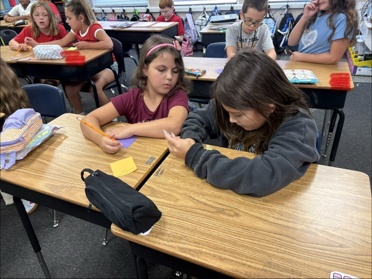 mrs. Myers class working on a writing project