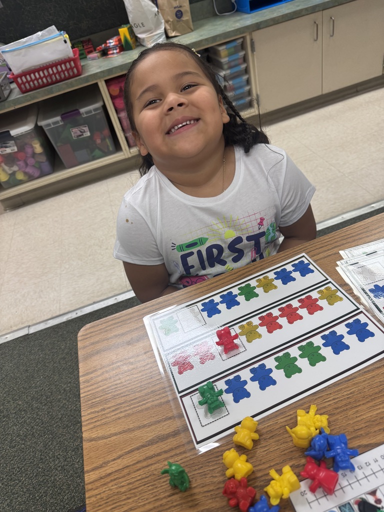 smiling student sitting at their desk