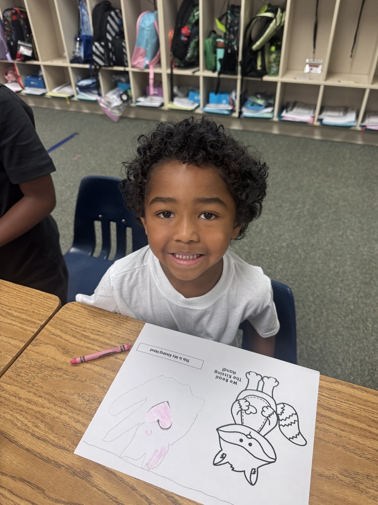 smiling student sitting at their desk