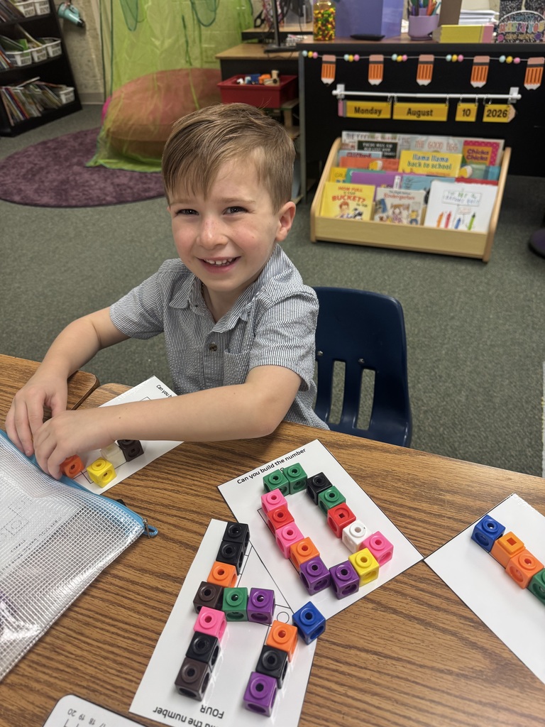 smiling student sitting at their desk