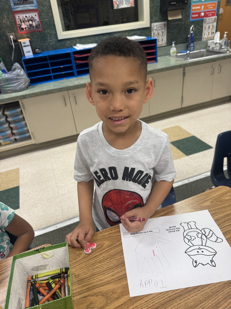 smiling student sitting at their desk