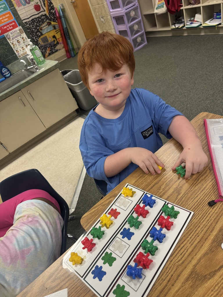 smiling student sitting at their desk