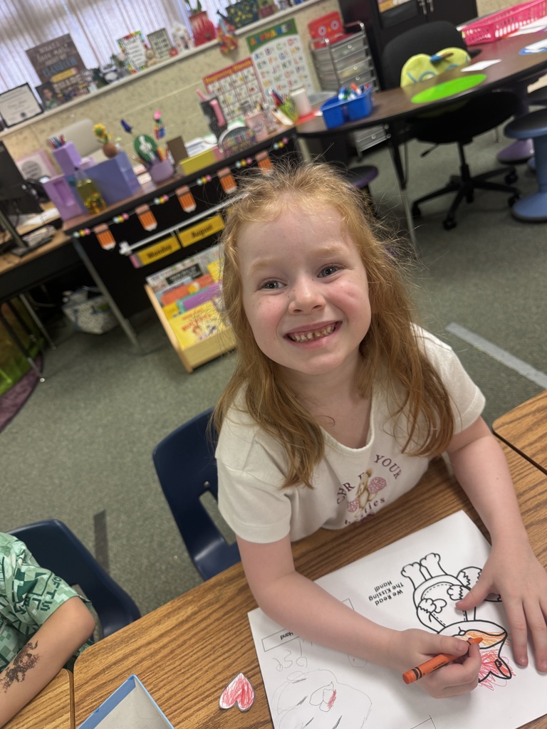 smiling student sitting at their desk