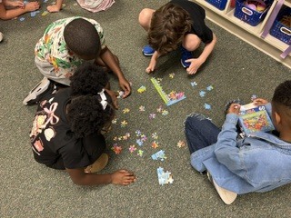 First day community building activity: Mrs. Morrell's 3rd graders working together to solve a puzzle.