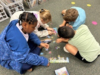 First day community building activity: Mrs. Morrell's 3rd graders working together to solve a puzzle.