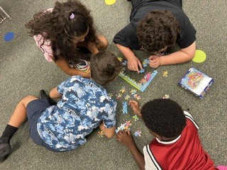 First day community building activity: Mrs. Morrell's 3rd graders working together to solve a puzzle.