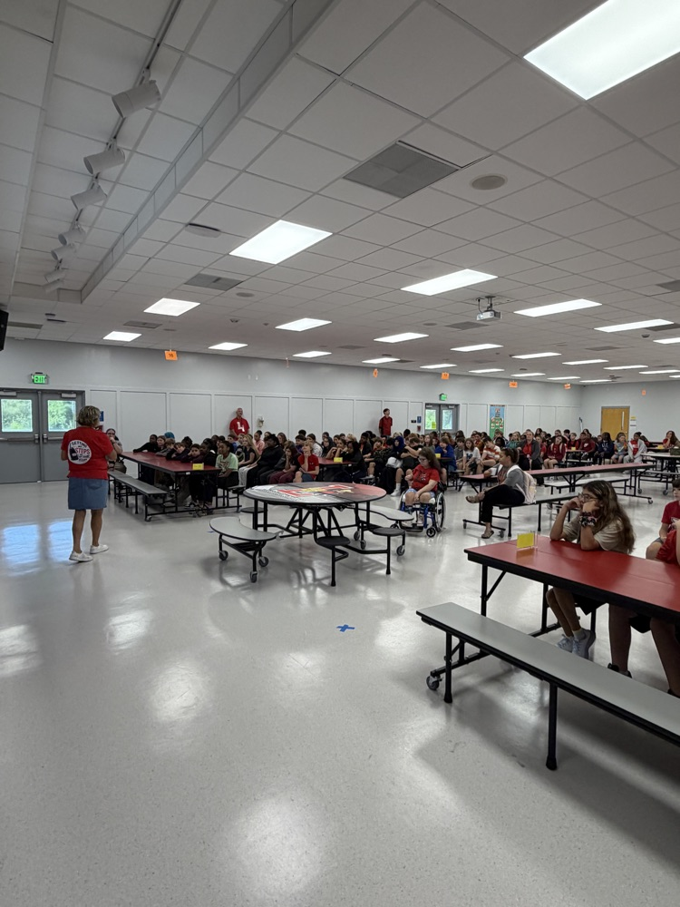 students sitting in the cafeteria for an assembly