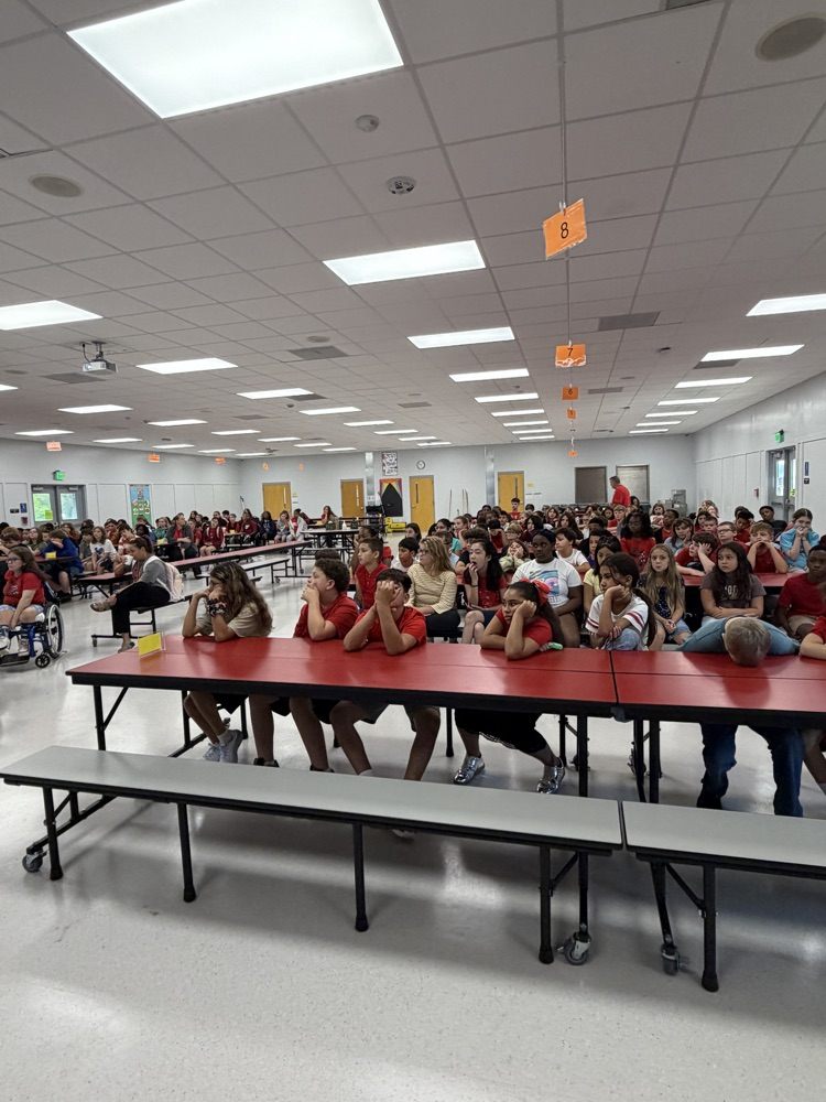 students sitting in the cafeteria for an assembly