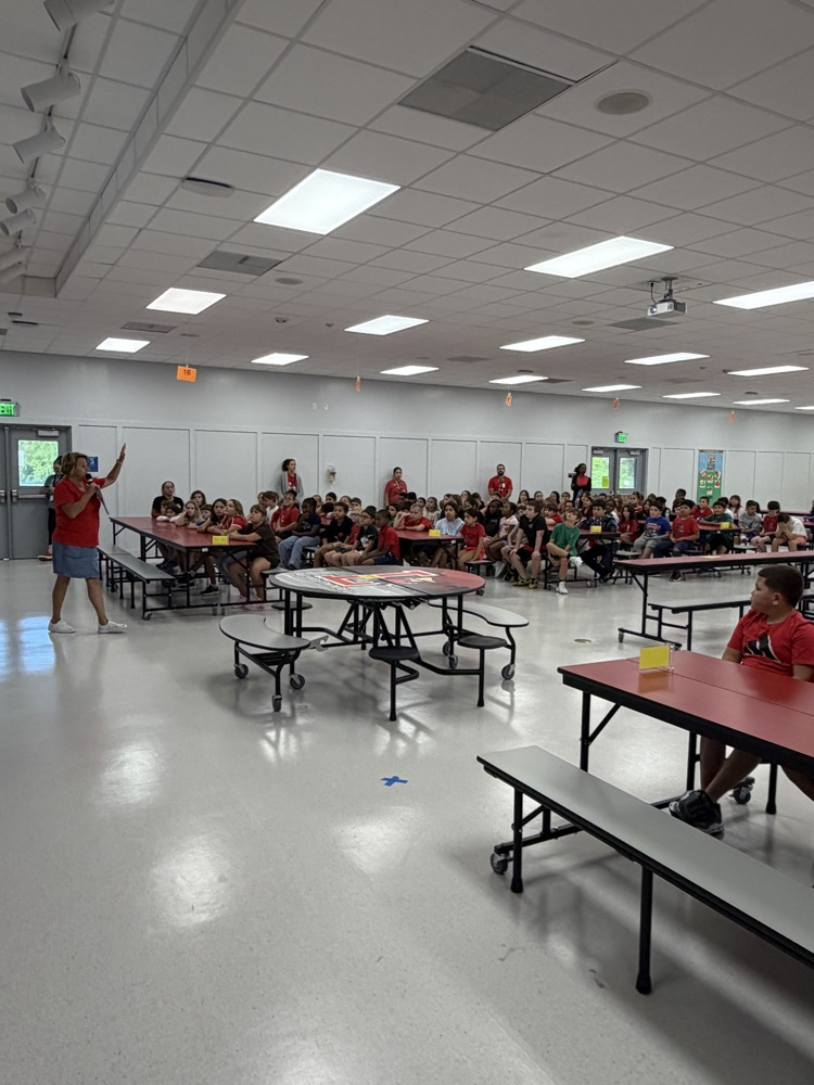 students sitting in the cafeteria for an assembly