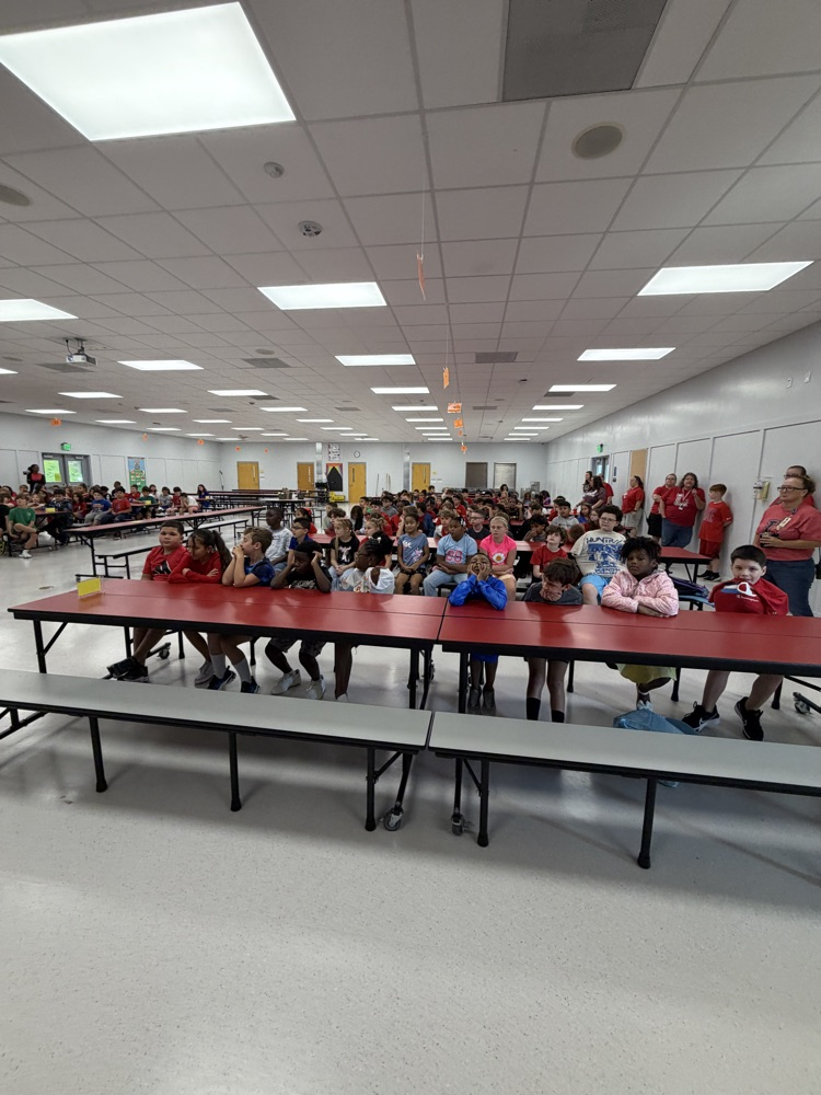 students sitting in the cafeteria for an assembly
