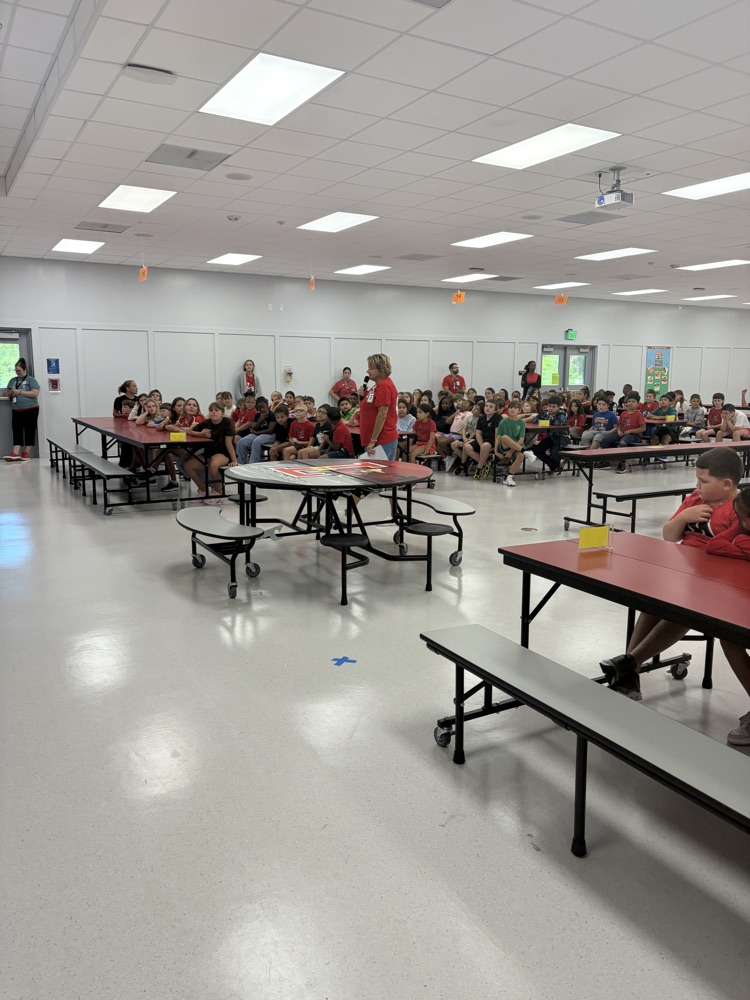 student sitting in the cafeteria for an assembly
