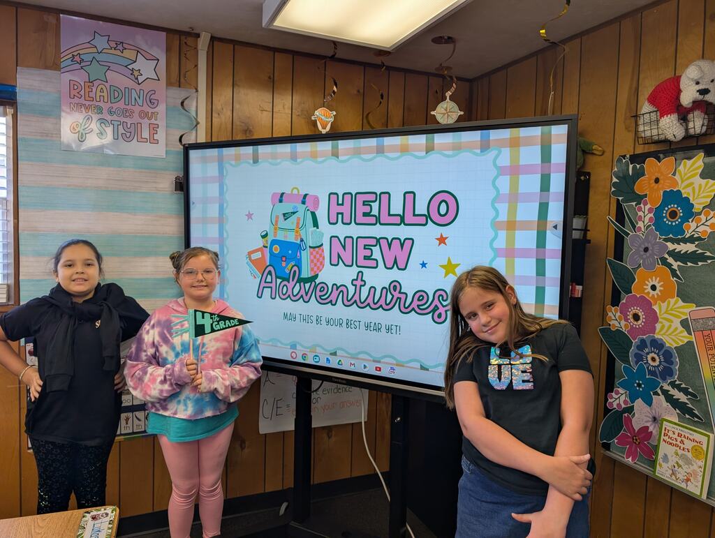 students standing in front of an interactive monitor 