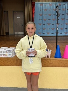 Student holding SOAR award