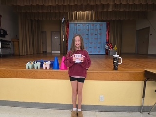 Student holding SOAR award