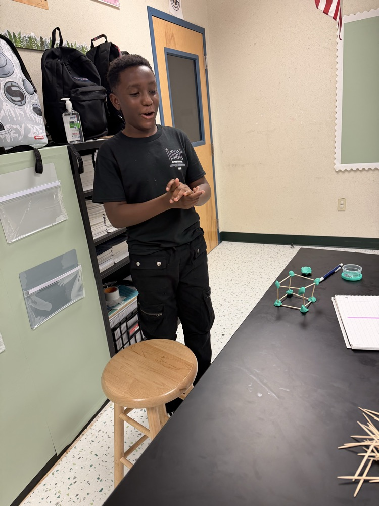 Students in their Science class working on their challenge of creating shapes using popsicle sticks and Play-Doh