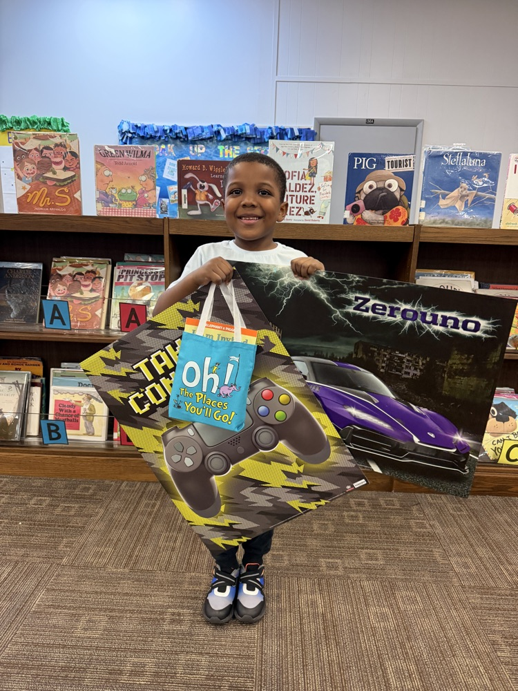 student who won the summer reading challenge with his prizes!