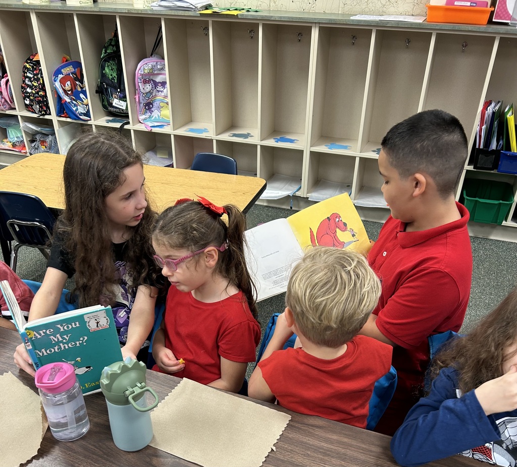 students reading to other students