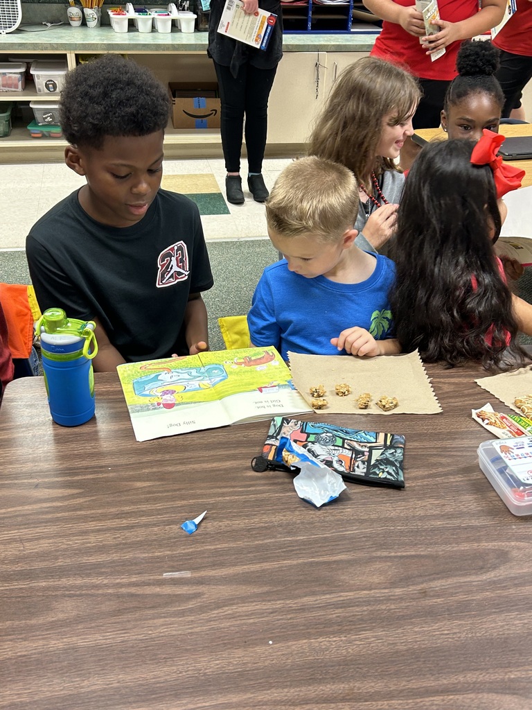 a student reading to another student