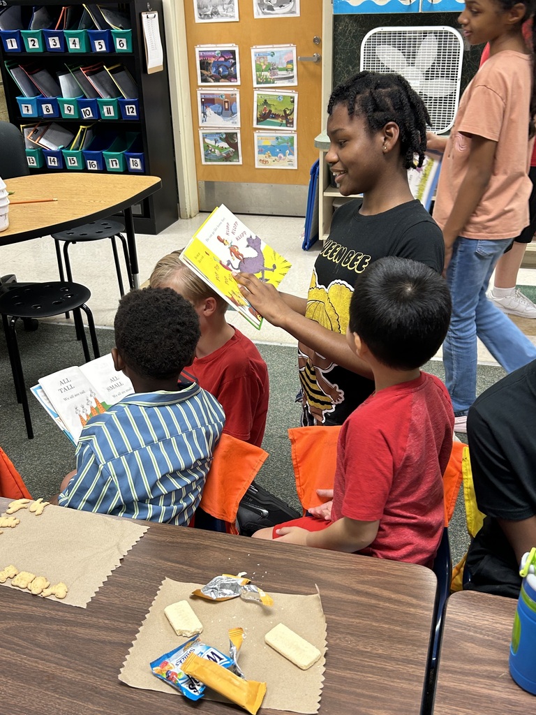 a student reading to another student
