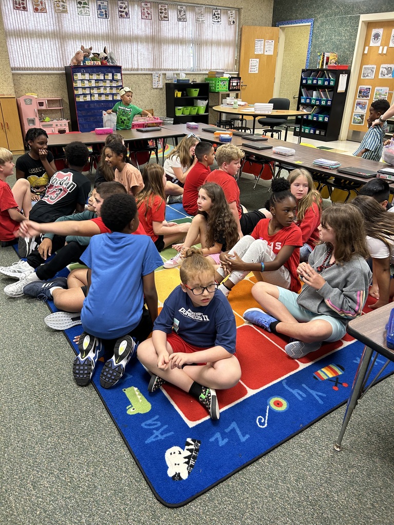 students sitting on the carpet