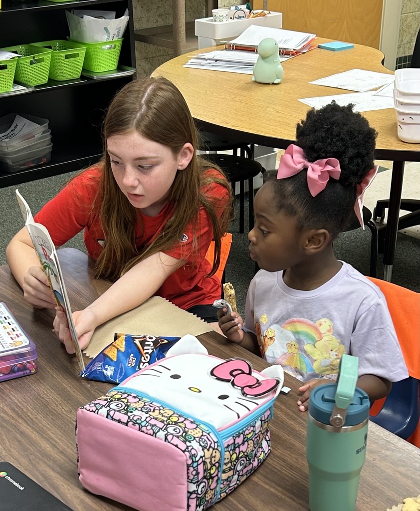 student reading to another student