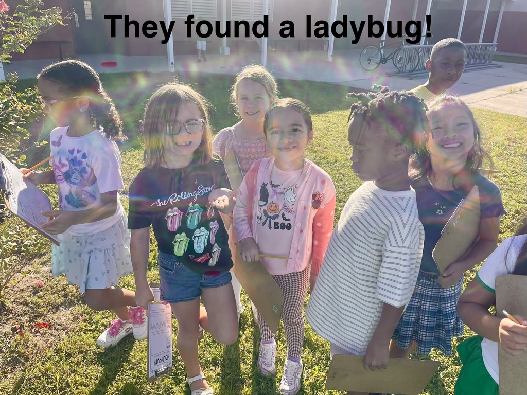Kids with bright smiles stand on a lawn, some holding papers, with text "They found a ladybug!"