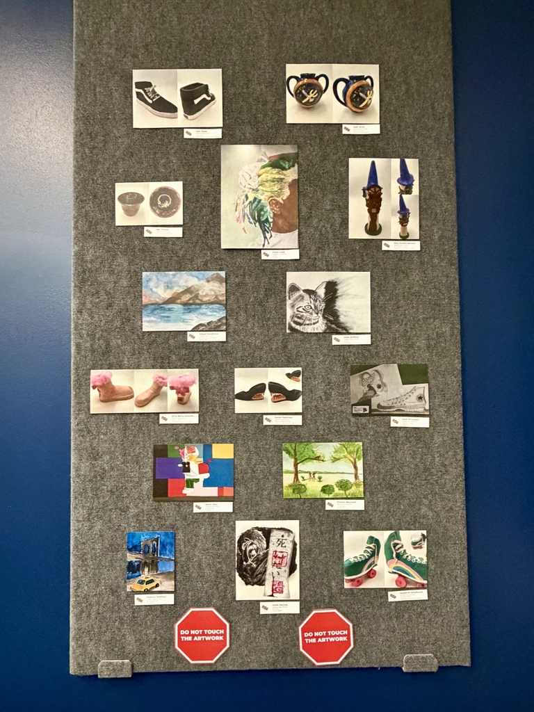 A bulletin board displays various photographs and drawings of shoes, cups, and objects. A red octagon sign is present.