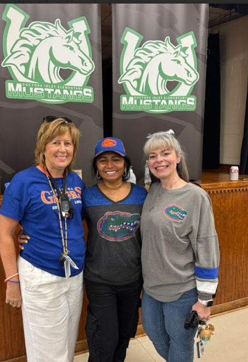 group of three women supporting Gators