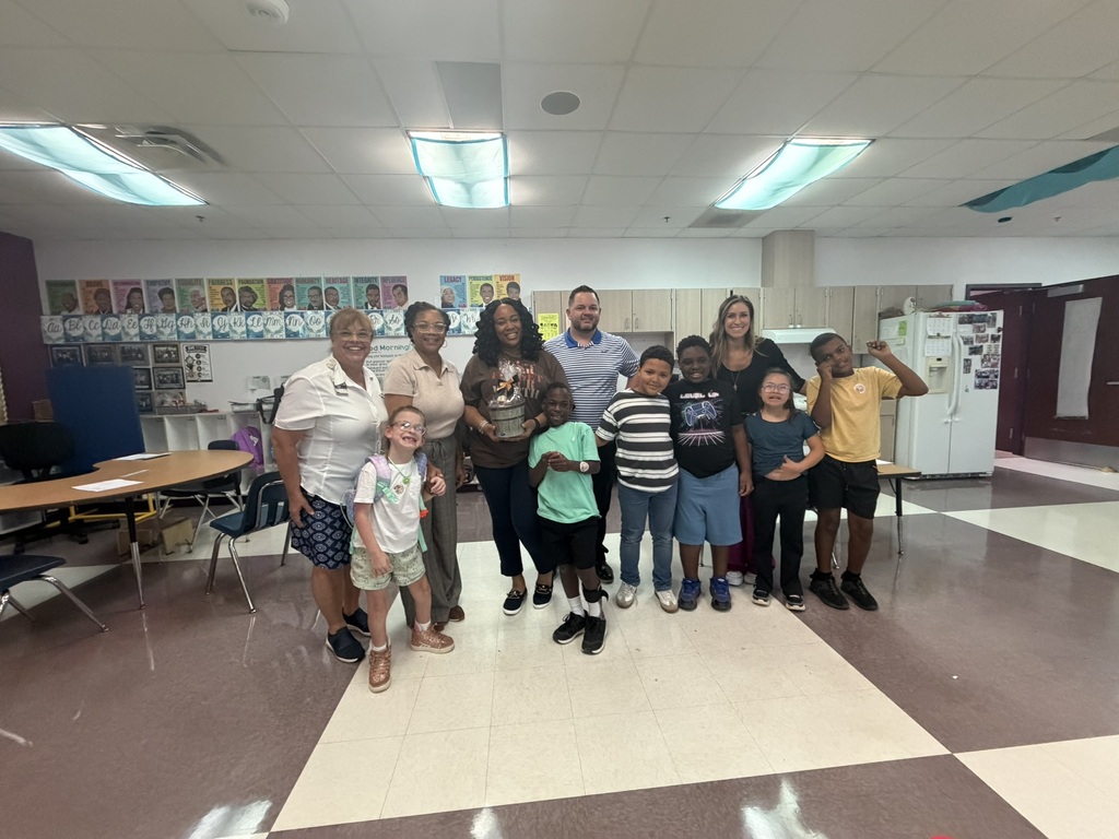 Admin team posing with Jennice Frazier, School-Related Employee of the Year, and students