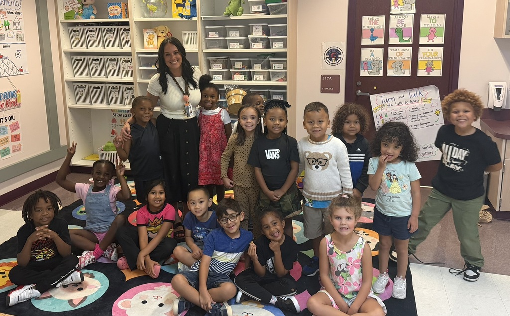 Mrs. Mullins, teacher of the year, posing with her students for a picture