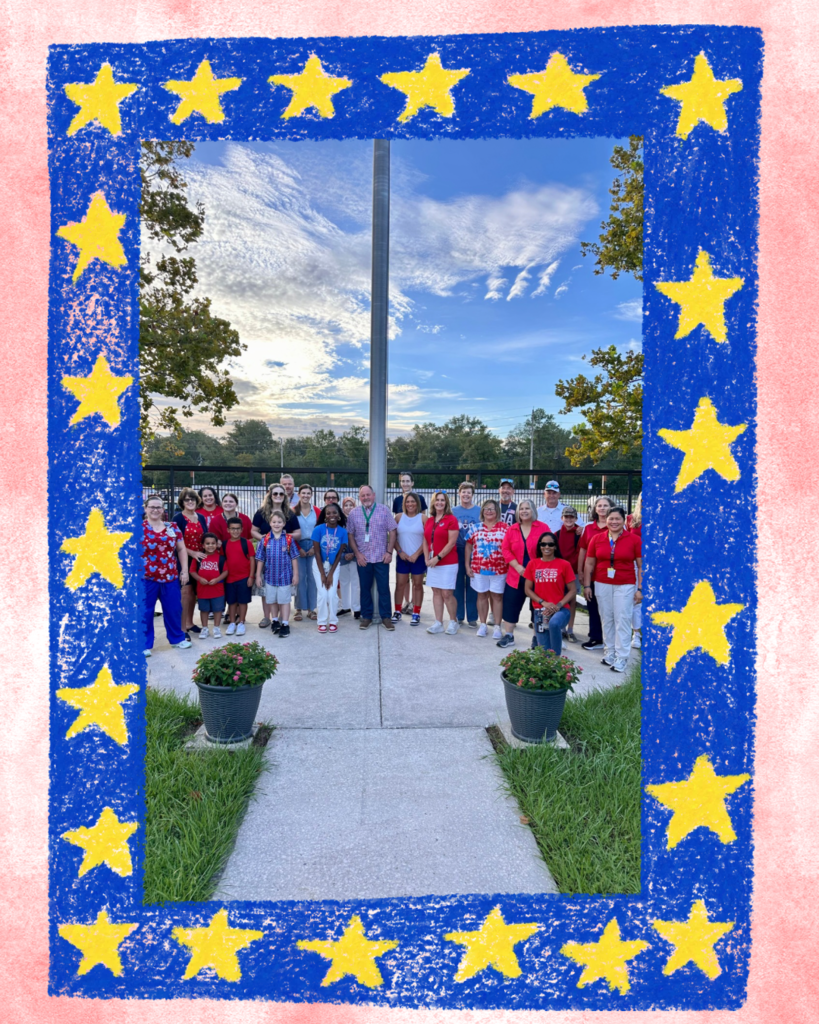 Montclair Monarchs standing around the flagpole honoring Patriot Day.
