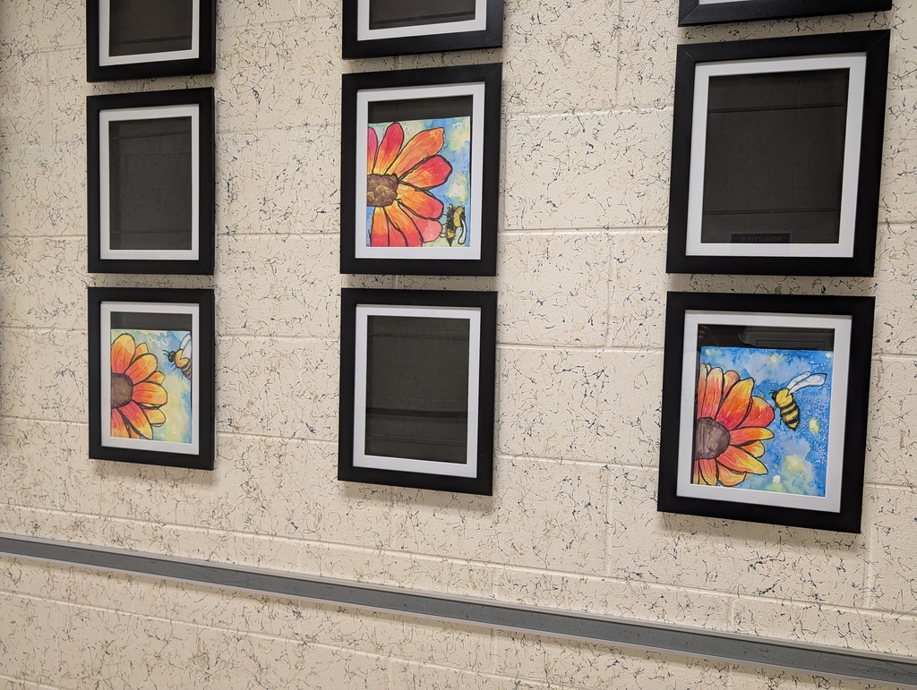 Six framed paintings on a white wall, three of which feature flowers and a bee.