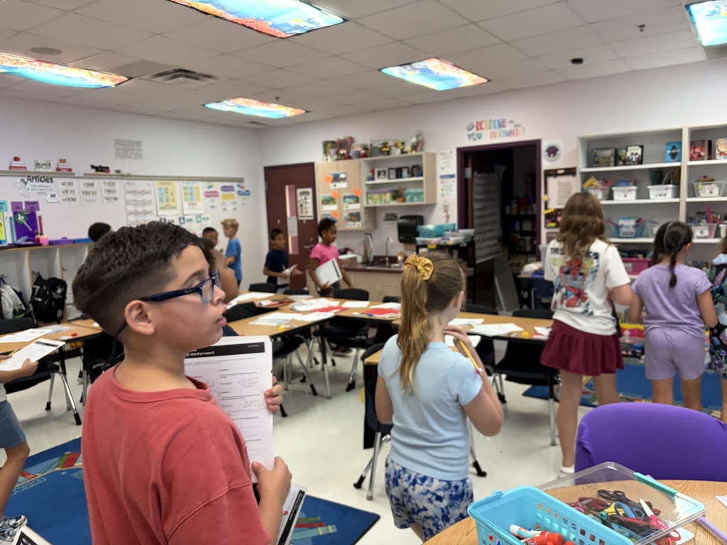 students walking around the classroom
