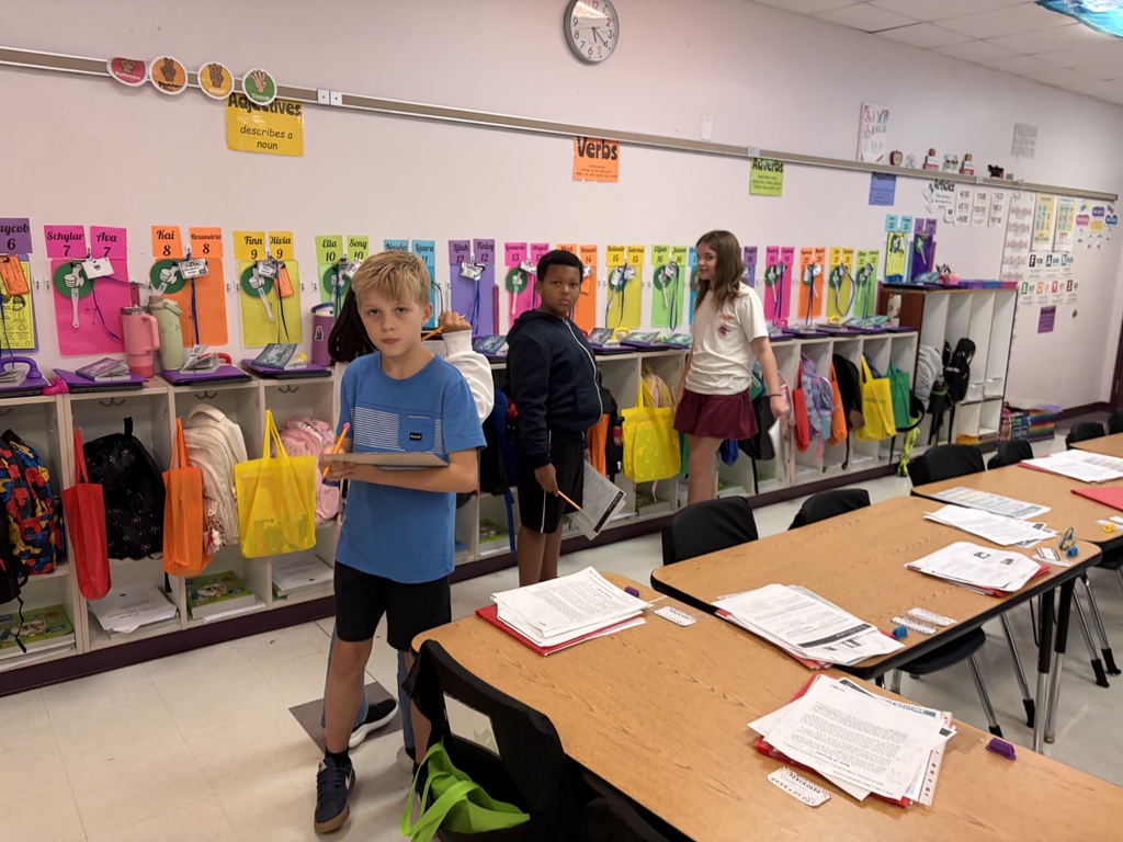 Three children in a classroom working together